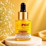 PGC Prism Glow Cosmetics Powerful Brightening Face Serum bottle with Vitamin C and Alpha Arbutin on a marble pedestal